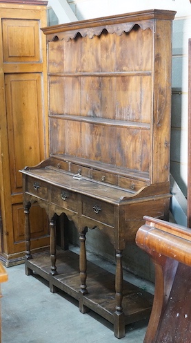 An 18th century style elm pot board dresser with boarded rack, length 132cm, depth 39cm, height 187cm